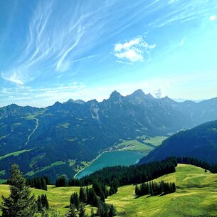 Mountain landscape with lake under blue sky with clouds
