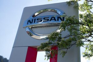 Nissan Logo auf Schild vor blauem Himmel