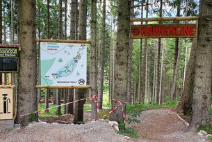 Forest path with map and wooden sign Rohrenkopf