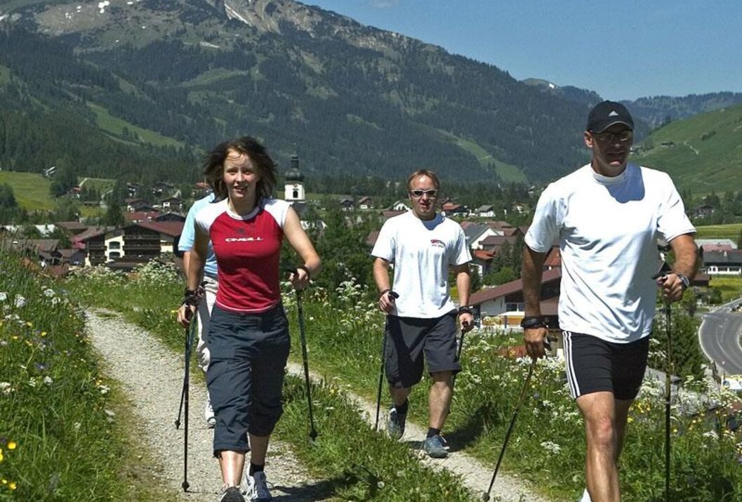Group Nordic walking in mountainous landscape