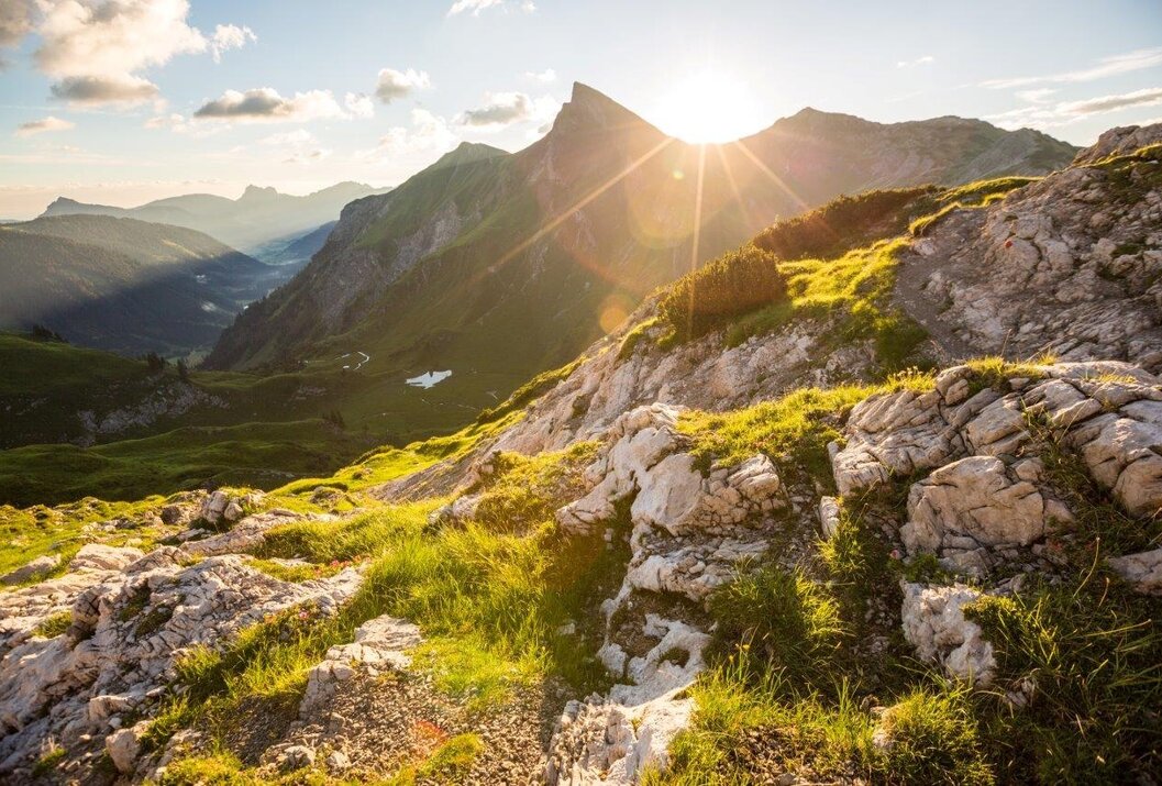 Berglandschaft mit Felsen, Gras und Sonnenschein