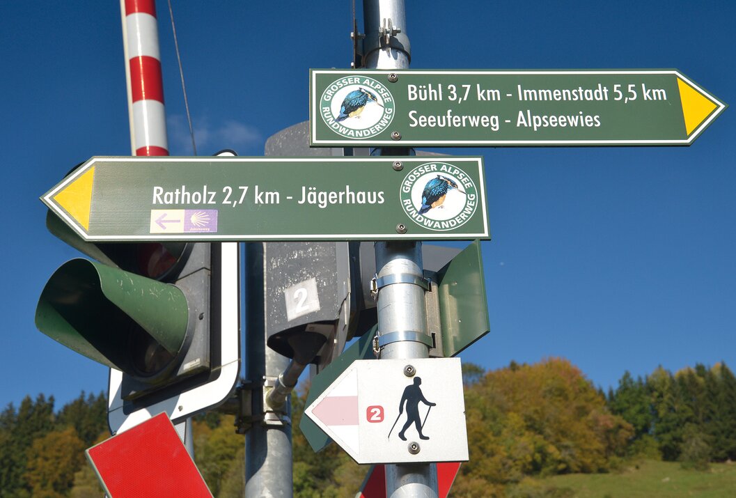 Wegweiser mit Zielen wie Bühl, Immenstadt, Ratholz und Jägerhaus an einem Mast