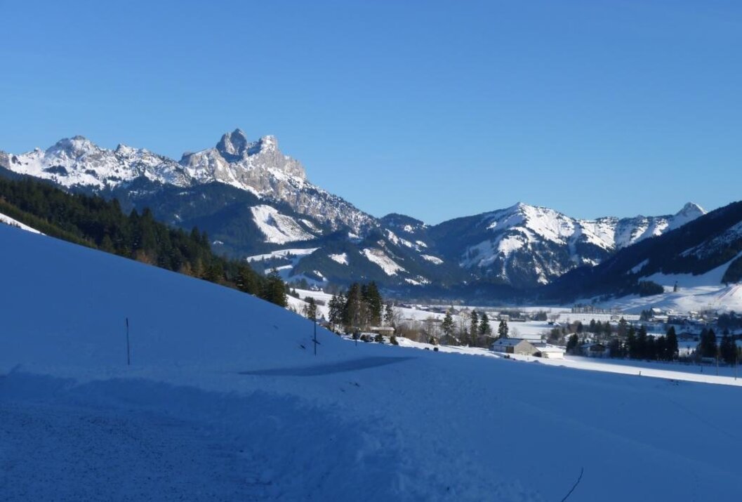 Winterlandschaft mit schneebedeckten Bergen und blauem Himmel