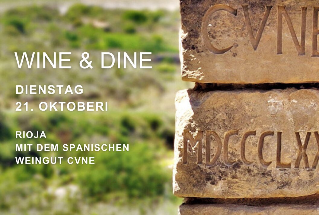 Gestapelte Steine mit Inschrift vor Landschaft, Ankündigung für Wine & Dine