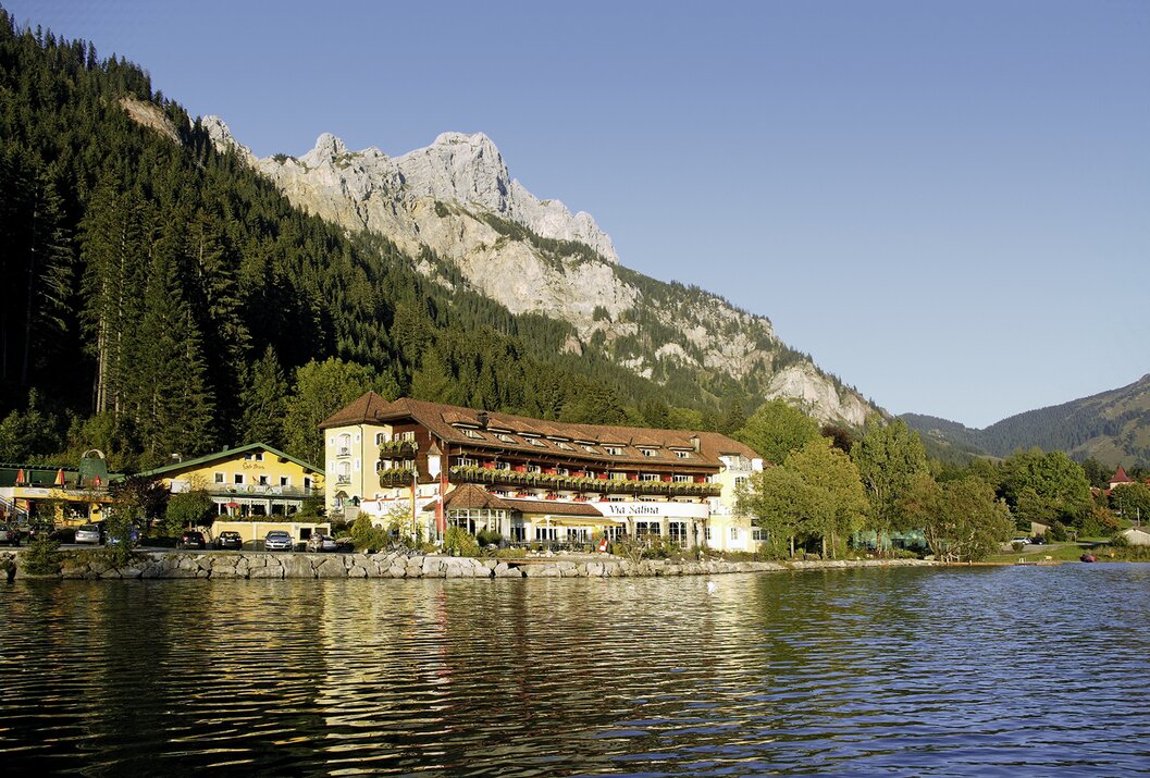 Hotel am See vor Bergkulisse