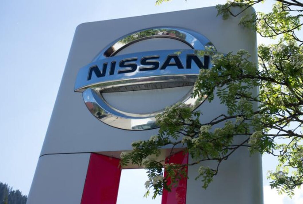 Nissan Logo auf Schild vor blauem Himmel
