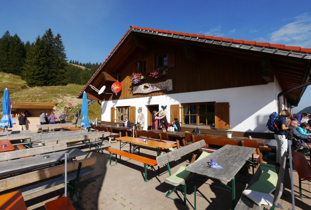 Traditional mountain hut with sunny outdoor terrace