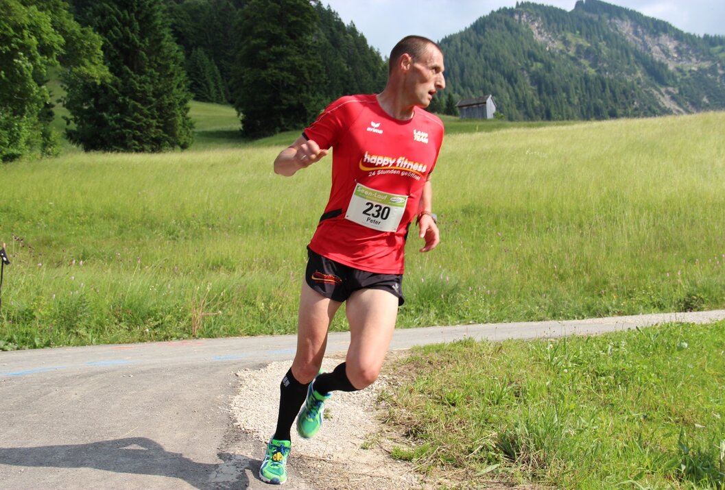 Athletic man trail running in an alpine landscape